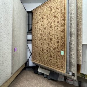 Beige floral area rug displayed in Carpet Tech showroom