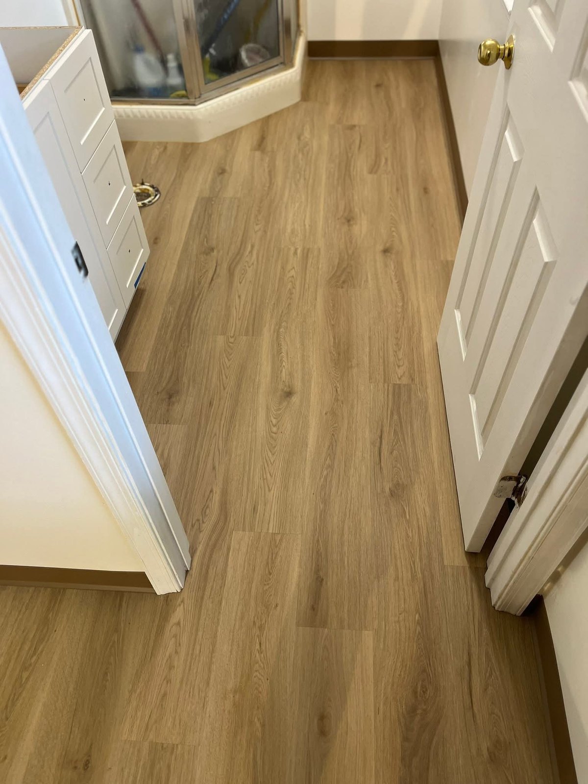 Light flooring near a hall and bath area